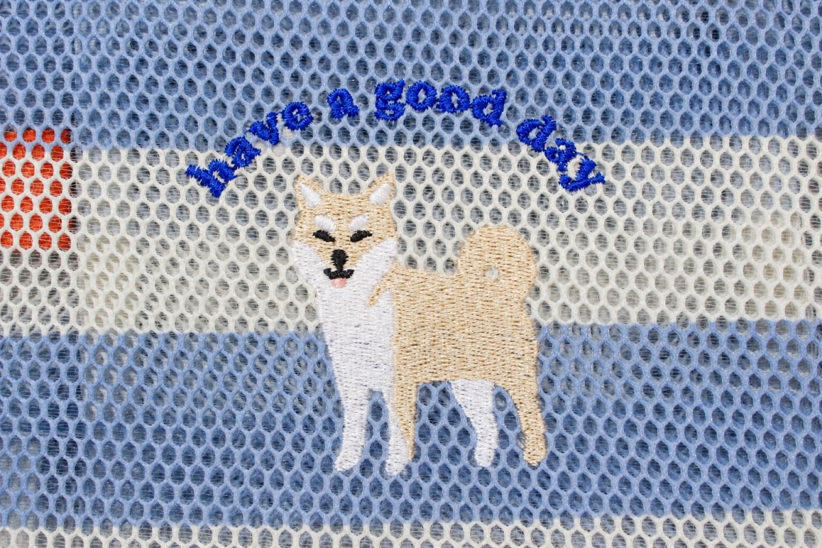 白と優しいブルーのボーダーメッシュに柴犬の刺繍。犬の上には「have a good day」と青の刺繍、持ち手はオレンジ